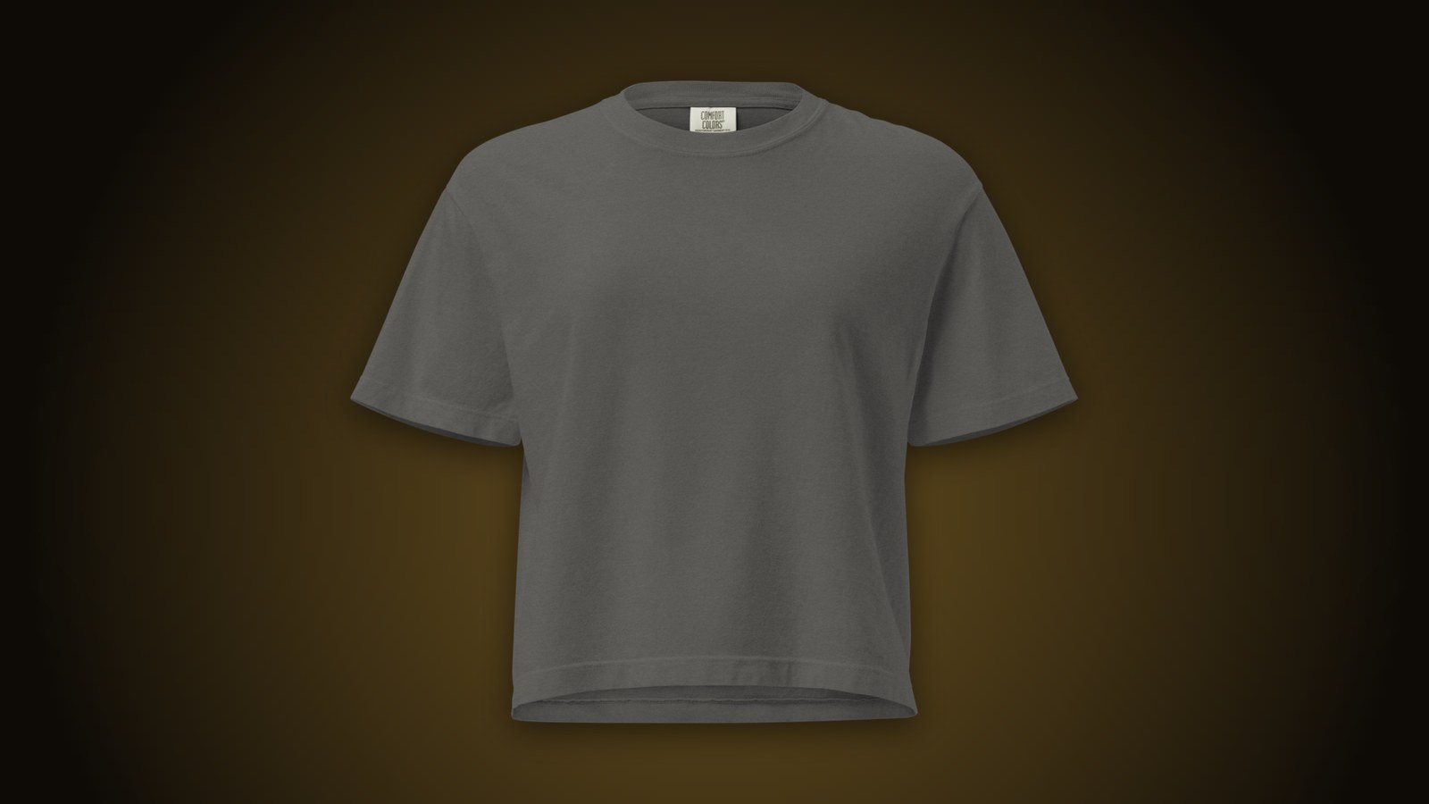 Pepper Comfort Colors garment-dyed boxy tee blank on a dark gold-lit background