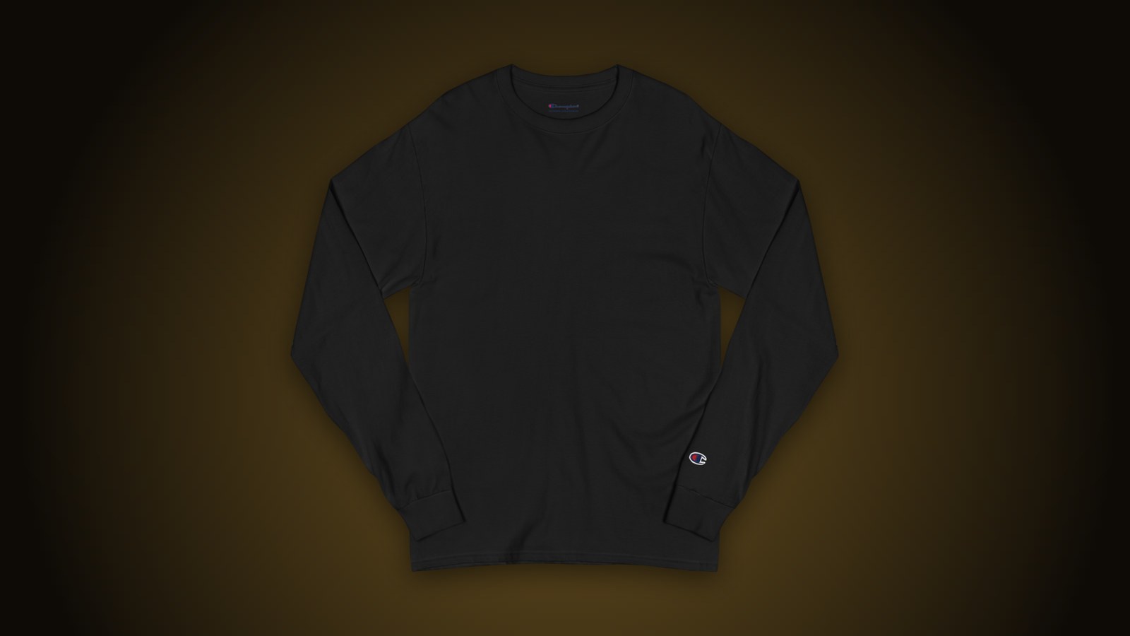 Black Champion CC8C long sleeve blank on a dark gold-lit background, ready for embroidery